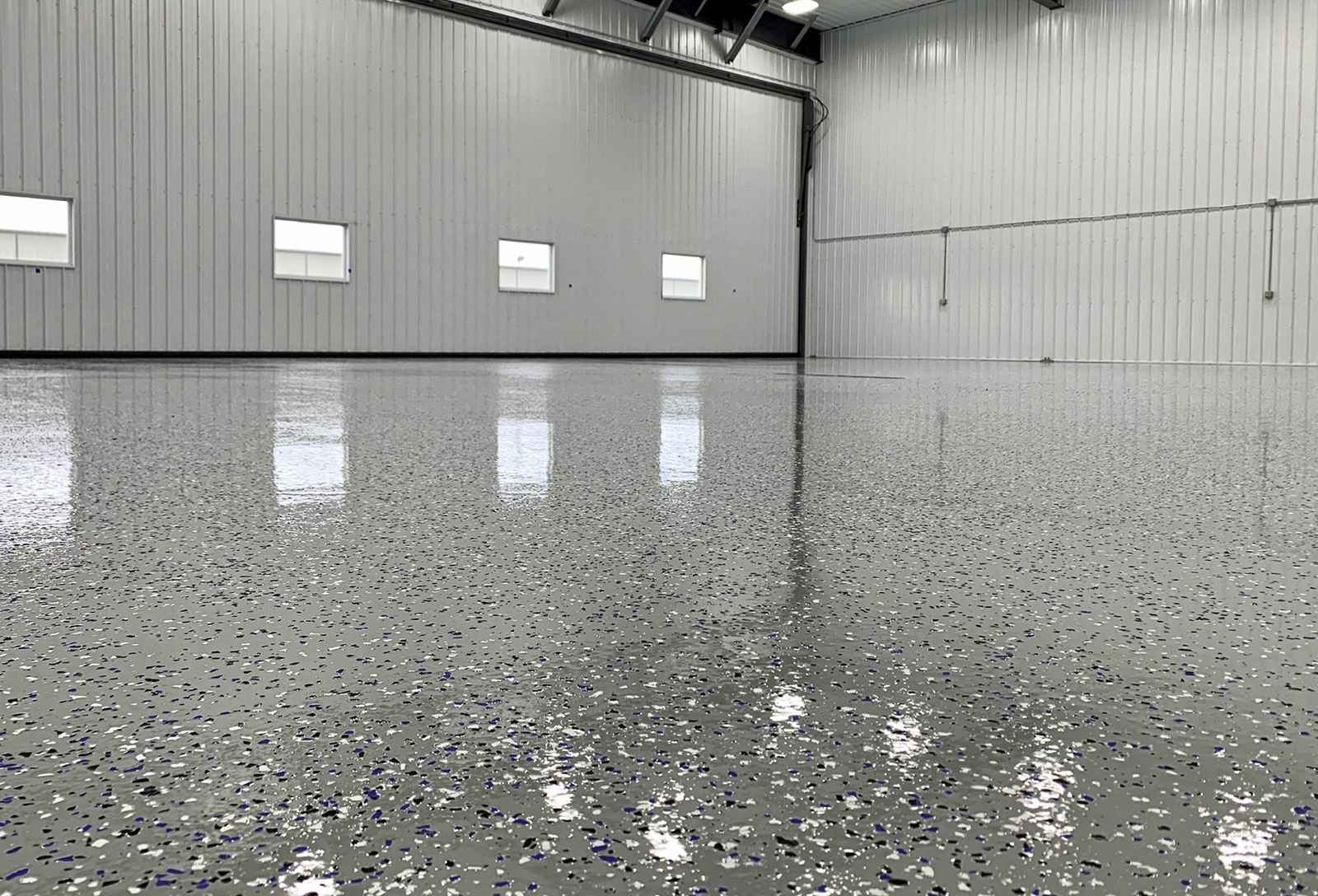 Finished gray flake epoxy floor after Kraken install
