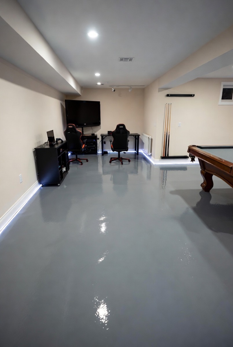 Finished basement with gray epoxy floor