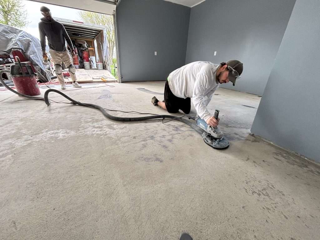 Kraken crew member grinding a concrete floor